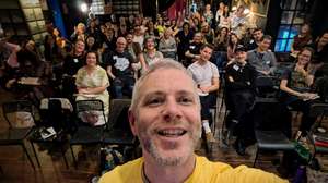 Finbarre Snarey takes a selfie in front of a packed audience at Tarot Cultures, a conference organised by Goldsmiths, University of London, after presenting his paper on Rider-Waite-Smith tarot reading as living heritage.