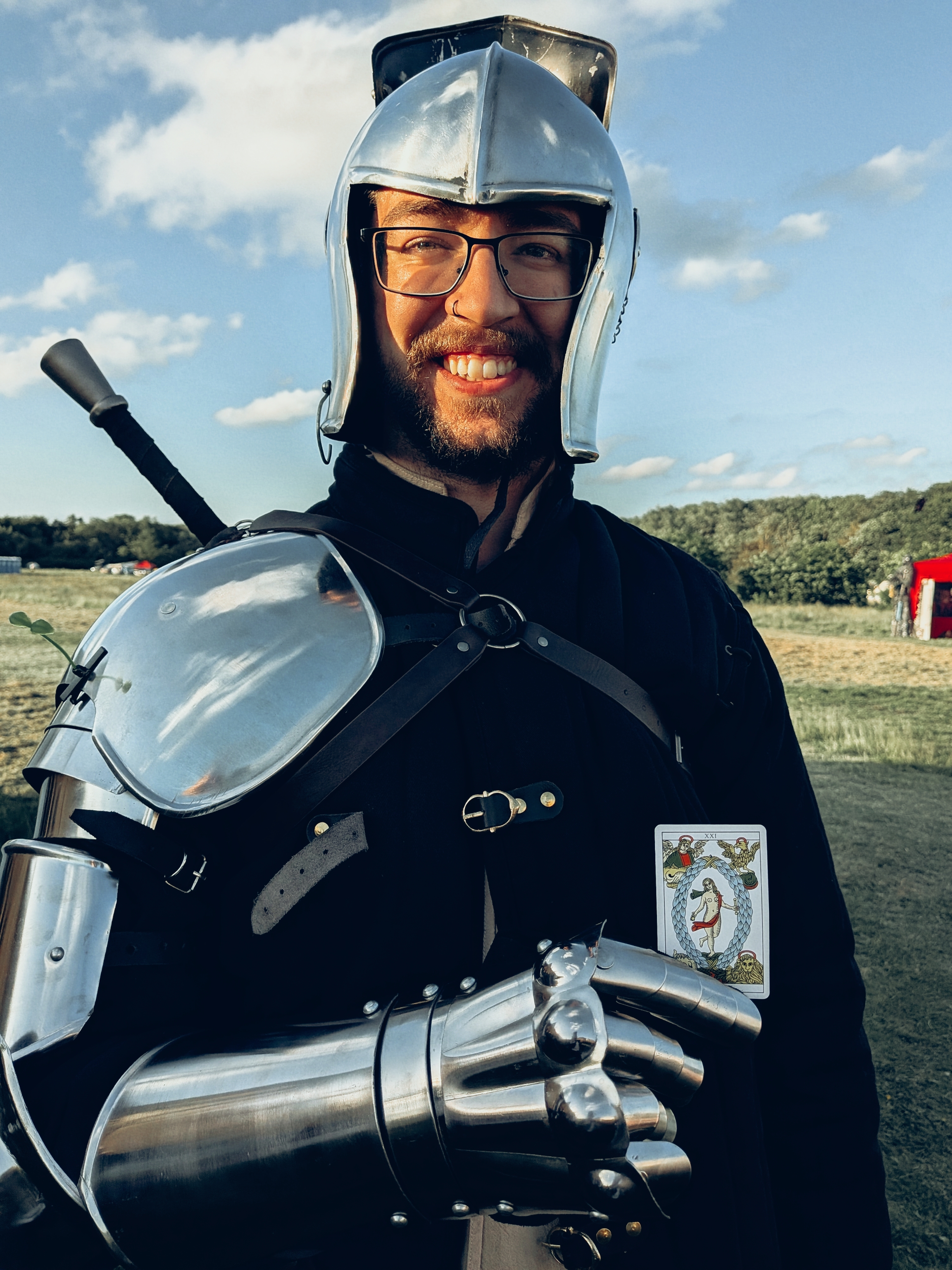 Armoured festival performer wearing the World tarot card during Tarot Interviews coverage at a renaissance event.