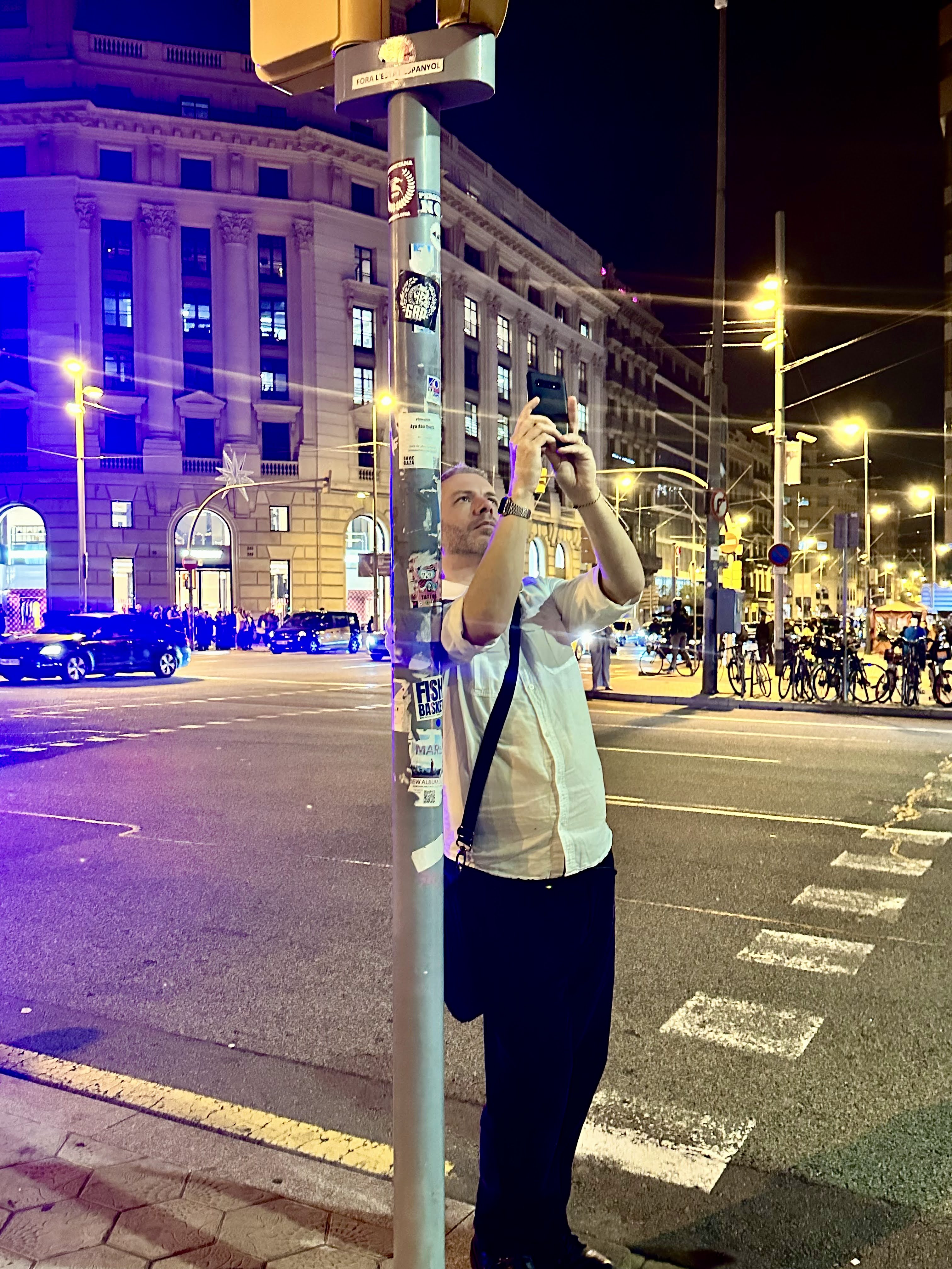 A picture of Finbarre Snarey in Barcelona taking a photograph in a street scene